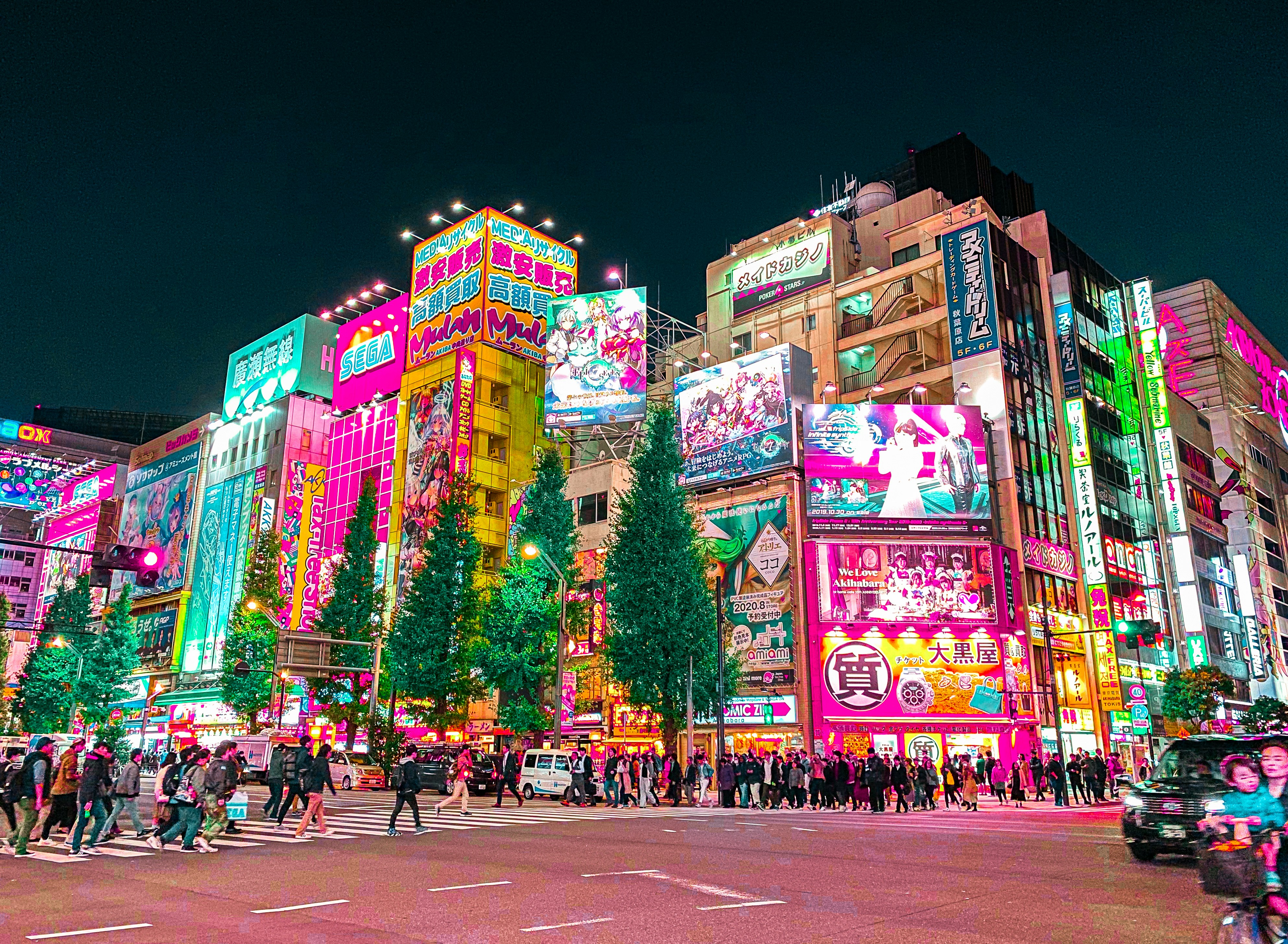 Busy street in Akihabara with bright electronic billboards and anime advertisements